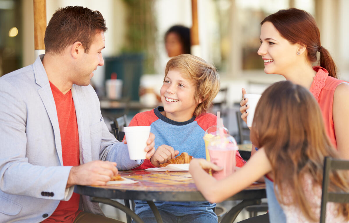 Family Enjoying Snack In Cafe