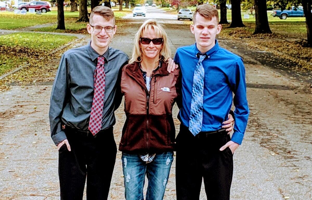 Dawn standing with her adult boys.