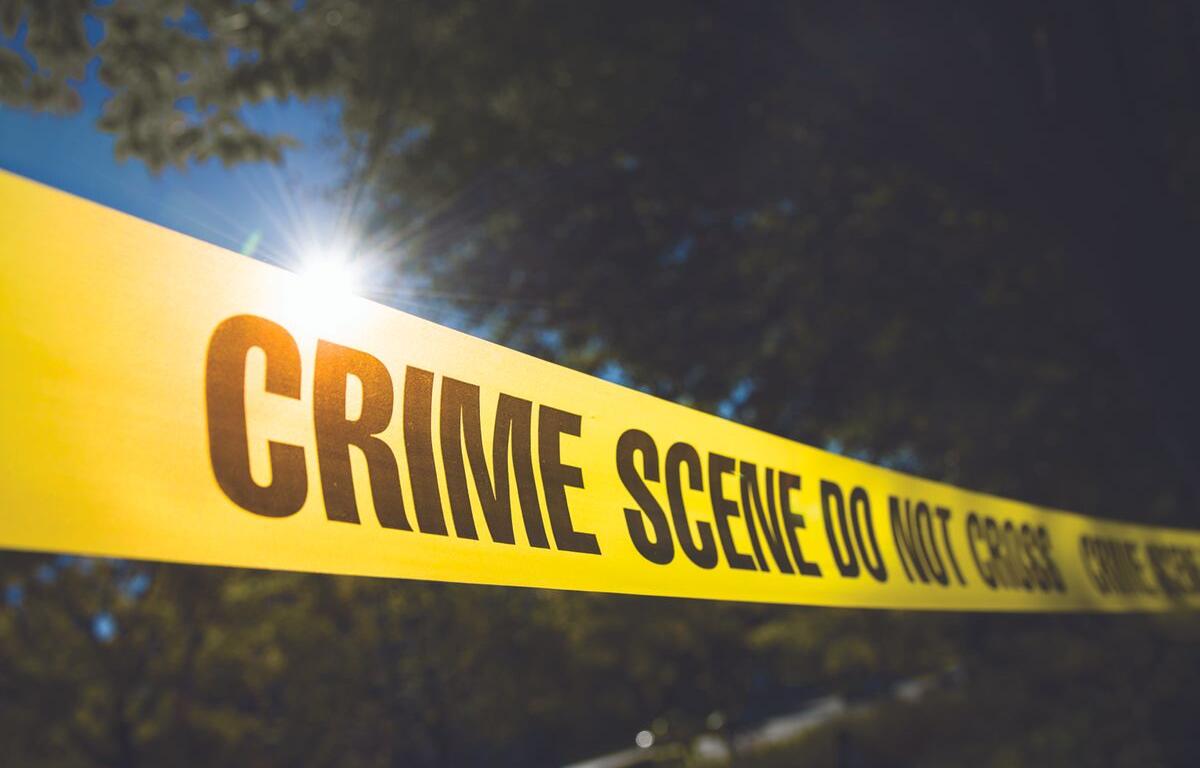 Police Tape in front of trees.