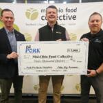 Three men hold a large check for $3,000 to Mid-Ohio Food Collective at a charity event.
