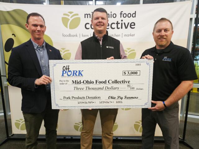 Three men hold a large check for $3,000 to Mid-Ohio Food Collective at a charity event.