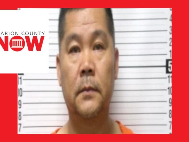 Mugshot-style photo of a man in an orange jumpsuit standing against a height chart; Marion County NOW logo overlays the left side.