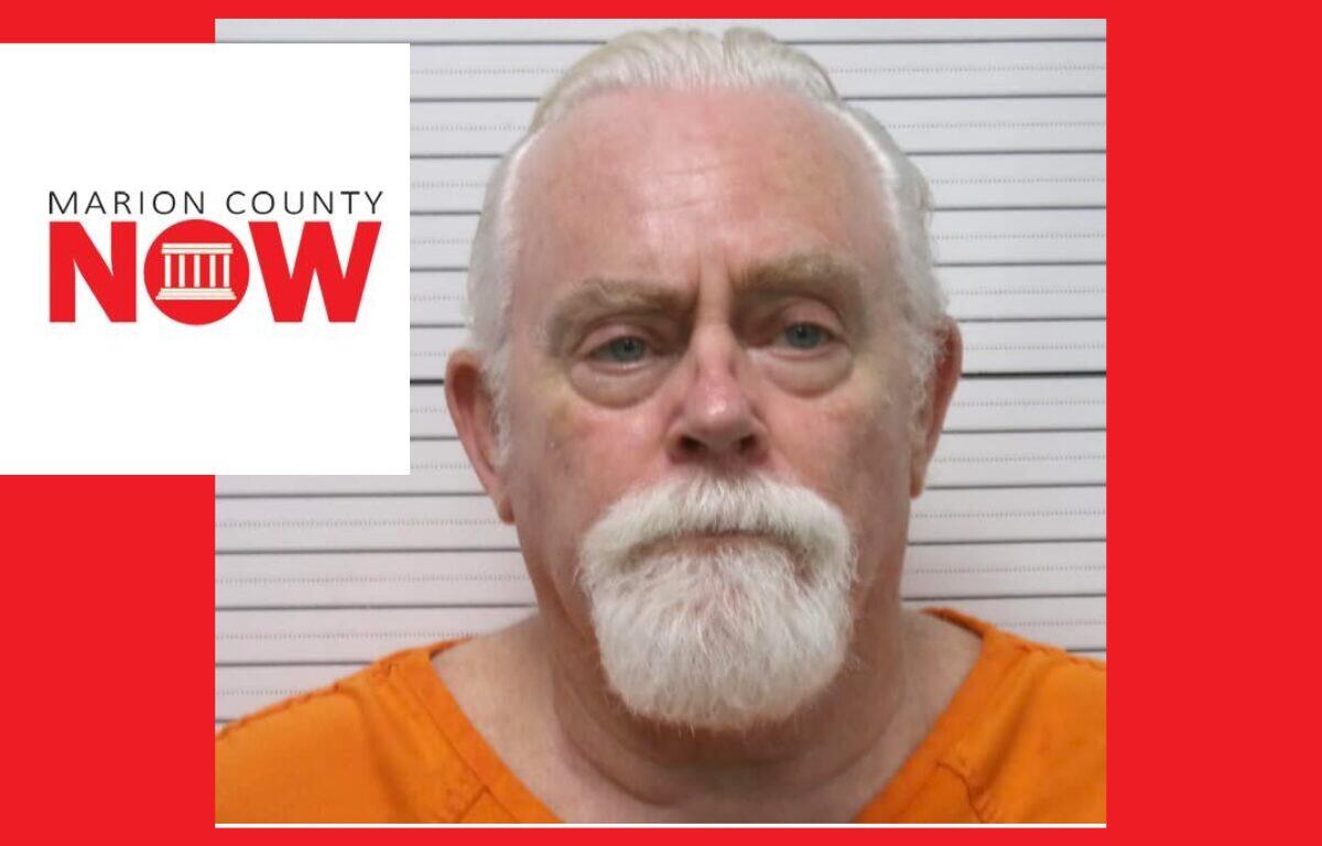 Mugshot of an older man with white hair and beard in an orange jumpsuit, against a height chart with Marion County NOW logo overlaid on the left.