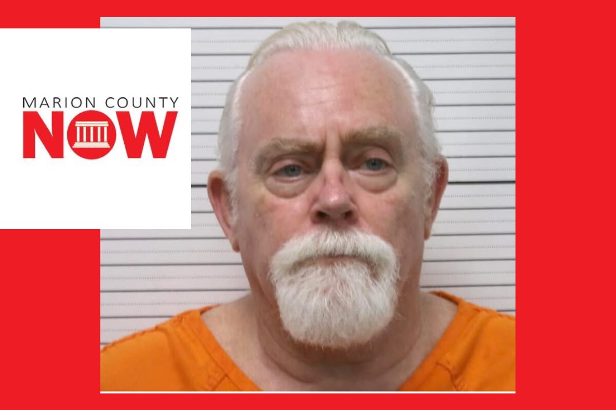 Mugshot of an older man with white hair and beard in an orange jumpsuit, against a height chart with Marion County NOW logo overlaid on the left.