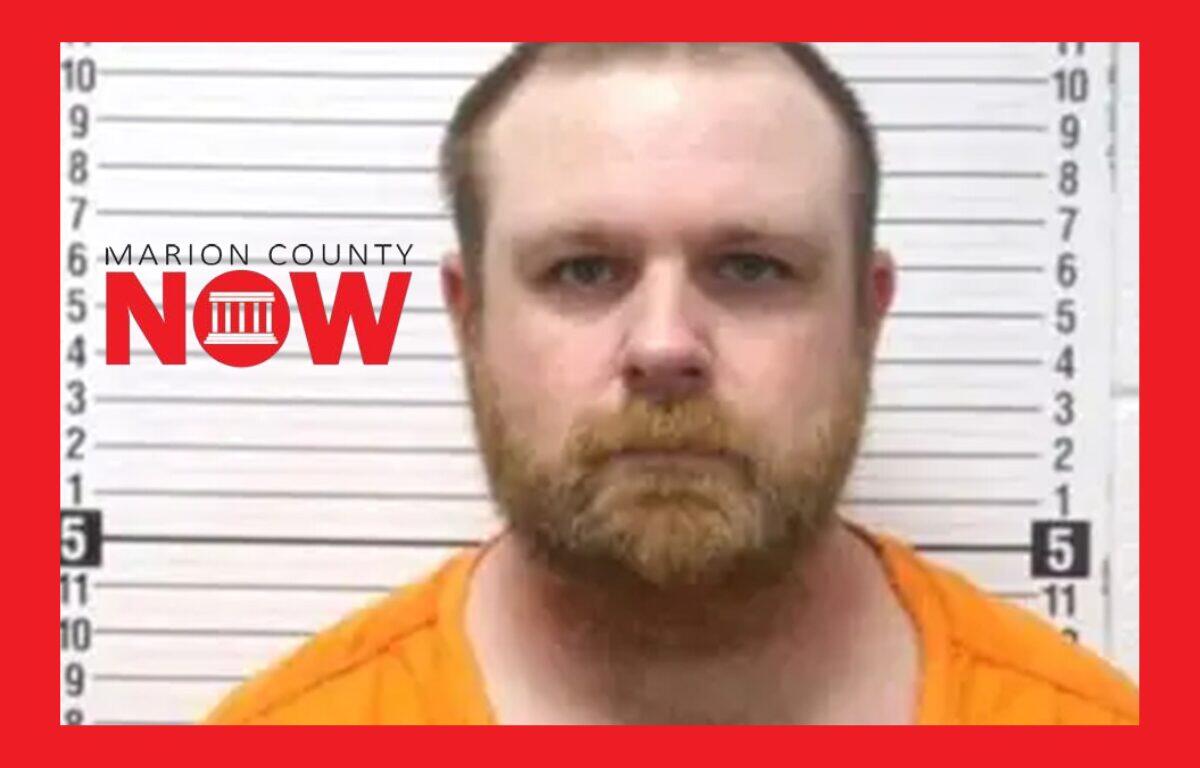 Mugshot of a bearded man in an orange jumpsuit standing against a height-chart wall, with a Marion County NOW logo on the left.